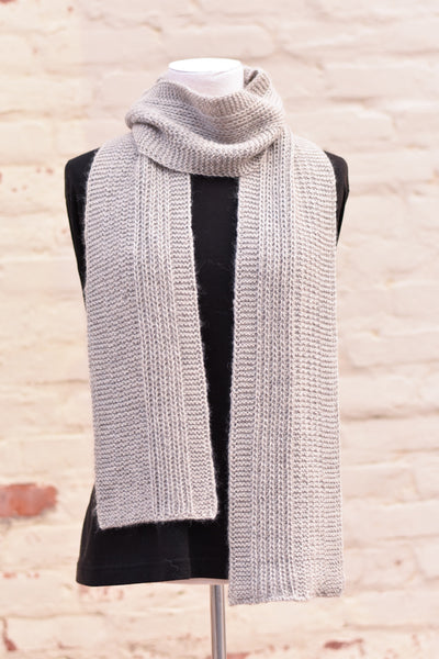 A light grey knitted scarf
