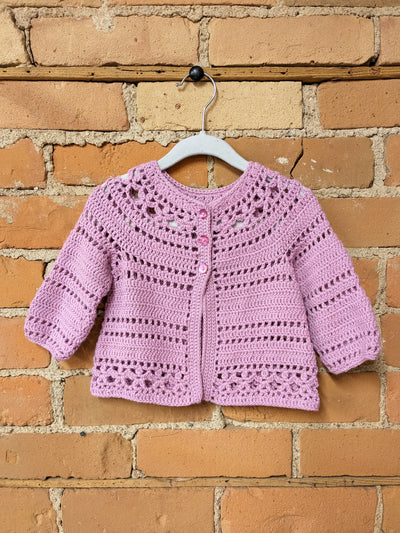 a pink crochet baby cardigan