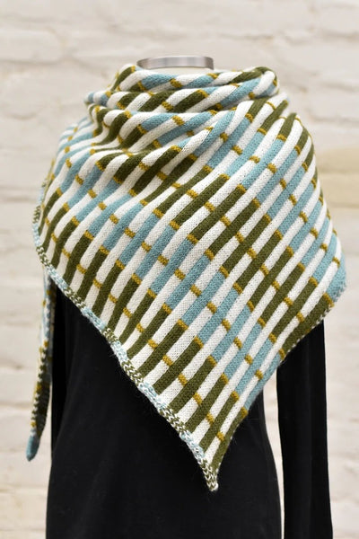 a knitted shawl in shades of cream, blue, olive green and mustard
