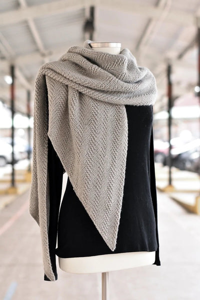  a grey knitted wrap