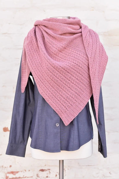 a pink shawl with cables