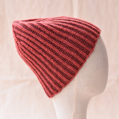 a coral brioche knitted hat